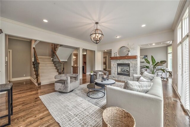 14606 Granada Rd, Leawood, KS 66224 - living room with wood finished floors, a stone fireplace, ornamental molding, stairs, and baseboards