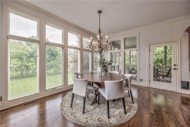 14606 Granada Rd, Leawood, KS 66224 - dining space with a chandelier, ornamental molding, healthy amount of natural light, dark wood-style floors, and baseboards