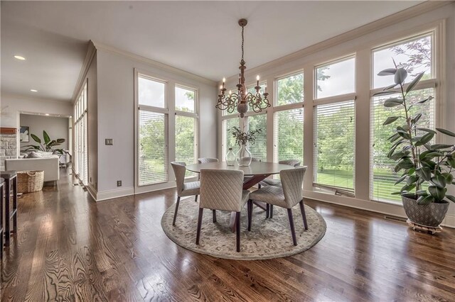 14606 Granada Rd, Leawood, KS 66224 - dining space featuring crown molding, a chandelier, baseboards, and wood finished floors