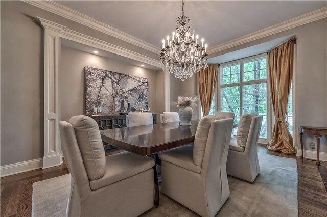 14606 Granada Rd, Leawood, KS 66224 - dining room featuring a chandelier, baseboards, wood finished floors, and crown molding