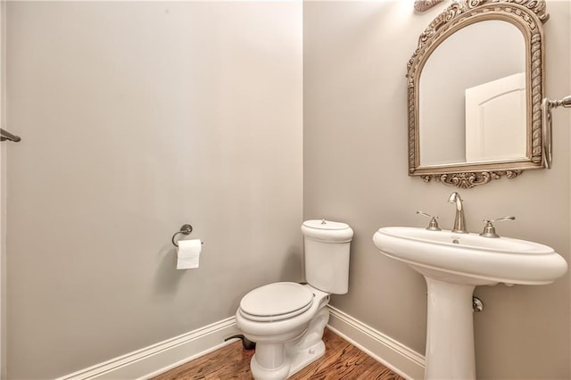 14606 Granada Rd, Leawood, KS 66224 - half bath with baseboards, wood finished floors, and toilet