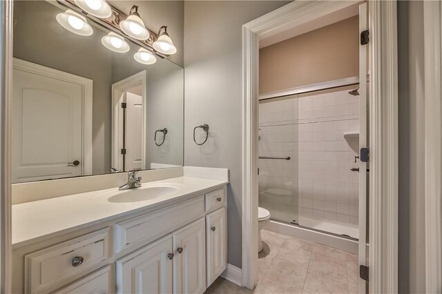 14606 Granada Rd, Leawood, KS 66224 - full bathroom with toilet, vanity, a stall shower, and tile patterned flooring