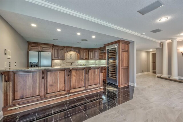 14606 Granada Rd, Leawood, KS 66224 - kitchen with stainless steel built in fridge, wine cooler, a kitchen bar, light stone countertops, and crown molding