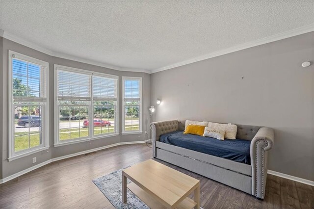 12890 S Greenwood St, Olathe, KS 66062 - living area featuring a textured ceiling, ornamental molding, healthy amount of natural light, wood finished floors, and baseboards