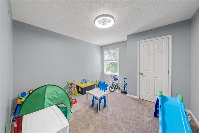 12890 S Greenwood St, Olathe, KS 66062 - rec room featuring a textured ceiling, carpet flooring, and baseboards