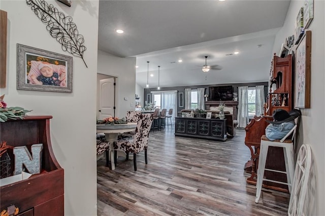 1609 Bluestem Dr, Ottawa, KS 66067 - dining space featuring wood finished floors, ceiling fan, recessed lighting, and a fireplace