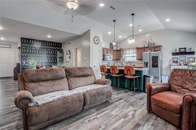 1609 Bluestem Dr, Ottawa, KS 66067 - living room featuring a ceiling fan, light wood-style floors, vaulted ceiling, and recessed lighting