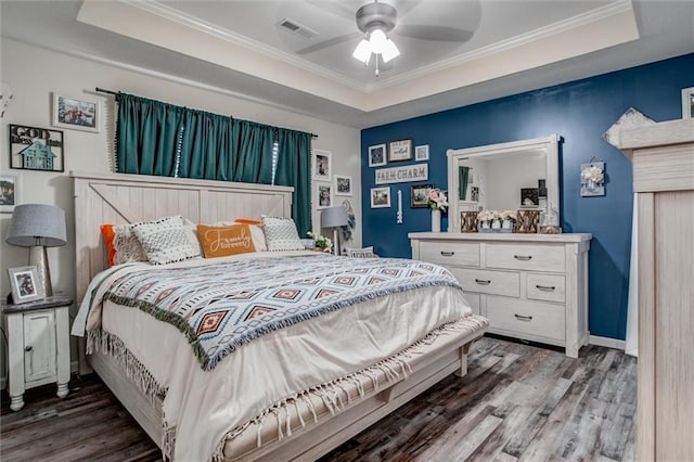 1609 Bluestem Dr, Ottawa, KS 66067 - bedroom with a raised ceiling, wood finished floors, ornamental molding, baseboards, and a ceiling fan