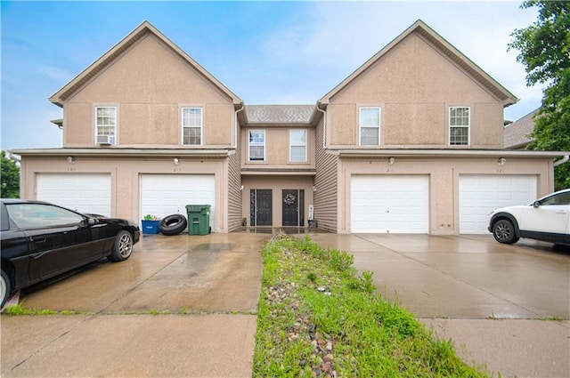 217 N 6th Ter, Louisburg, KS 66053 - multi unit property with a garage, driveway, and stucco siding