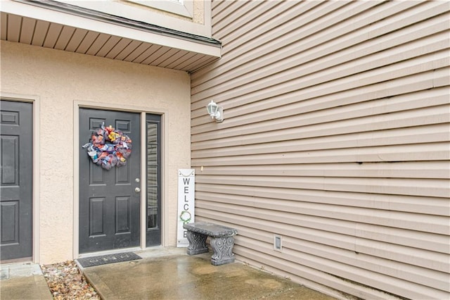 217 N 6th Ter, Louisburg, KS 66053 - doorway to property featuring stucco siding