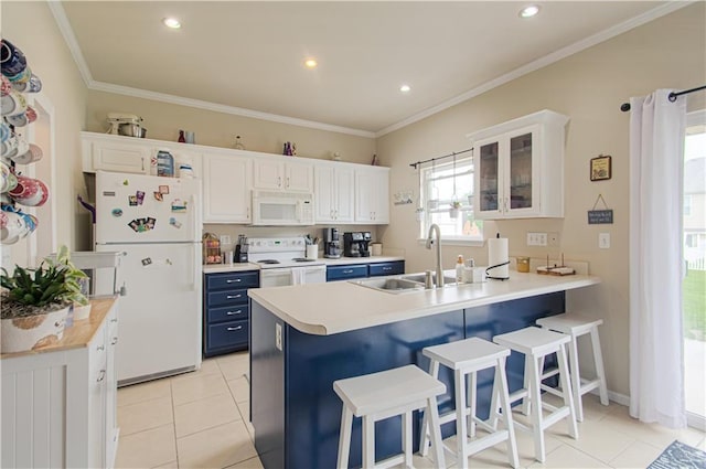 217 N 6th Ter, Louisburg, KS 66053 - kitchen featuring white appliances, blue cabinets, a peninsula, a breakfast bar area, and a sink
