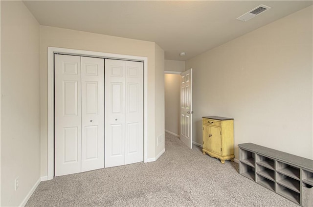 217 N 6th Ter, Louisburg, KS 66053 - unfurnished bedroom with carpet flooring, a closet, and baseboards