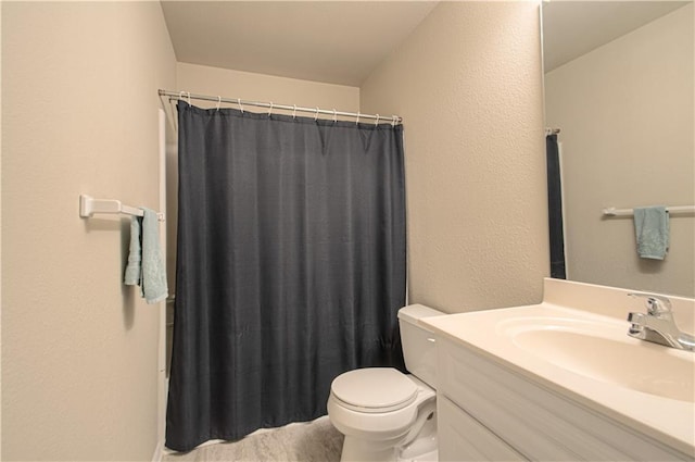 217 N 6th Ter, Louisburg, KS 66053 - bathroom with vanity, toilet, a textured wall, and curtained shower