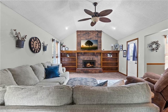 1805 N Lazy Branch Rd, Independence, MO 64058 - carpeted living area featuring ceiling fan, vaulted ceiling, a fireplace, and a textured ceiling