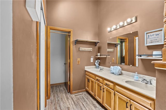 1805 N Lazy Branch Rd, Independence, MO 64058 - full bathroom featuring double vanity, wood finished floors, and baseboards