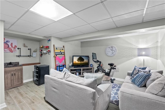 1805 N Lazy Branch Rd, Independence, MO 64058 - living area with light wood-type flooring, baseboards, and a drop ceiling