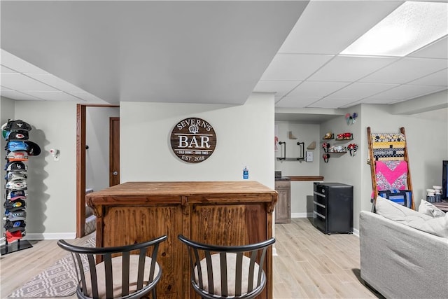 1805 N Lazy Branch Rd, Independence, MO 64058 - indoor dry bar featuring a drop ceiling, light wood finished floors, and baseboards