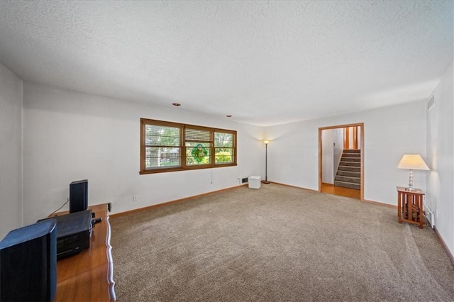 1107 E 110th St, Kansas City, MO 64131 - unfurnished living room with a textured ceiling, carpet floors, stairs, and baseboards