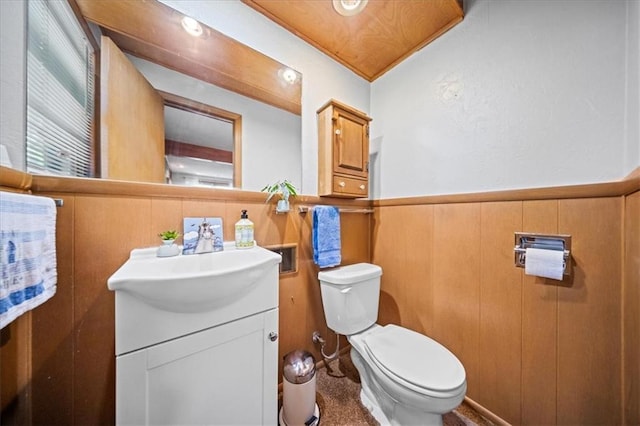 1107 E 110th St, Kansas City, MO 64131 - bathroom featuring toilet, vanity, and wainscoting
