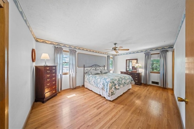 1107 E 110th St, Kansas City, MO 64131 - bedroom with a textured ceiling, light wood-style floors, baseboards, ceiling fan, and crown molding
