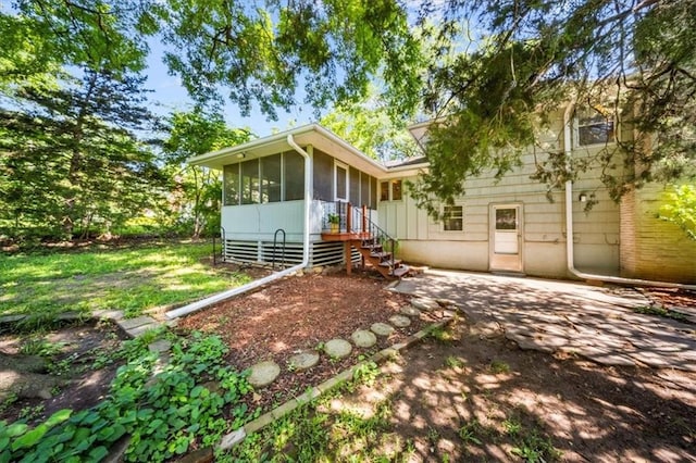 1107 E 110th St, Kansas City, MO 64131 - view of front of home featuring a sunroom and a patio area