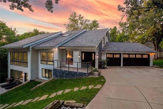 12204 Catalina St, Leawood, KS 66209 - view of front of home featuring concrete driveway, a garage, a front lawn, and a shingled roof