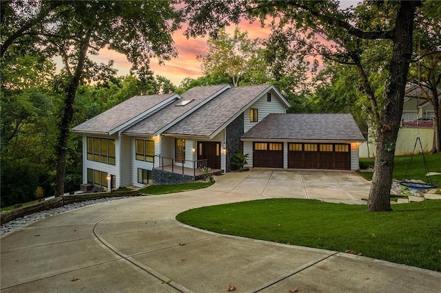 12204 Catalina St, Leawood, KS 66209 - view of front of house with concrete driveway, a garage, a lawn, and roof with shingles