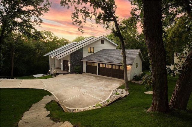 12204 Catalina St, Leawood, KS 66209 - view of front of house with a garage, driveway, and a lawn