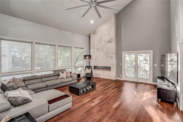 12204 Catalina St, Leawood, KS 66209 - living area featuring high vaulted ceiling, ceiling fan, wood finished floors, and a tile fireplace