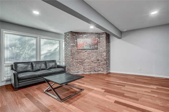 12204 Catalina St, Leawood, KS 66209 - living room featuring brick wall, light wood-type flooring, and recessed lighting