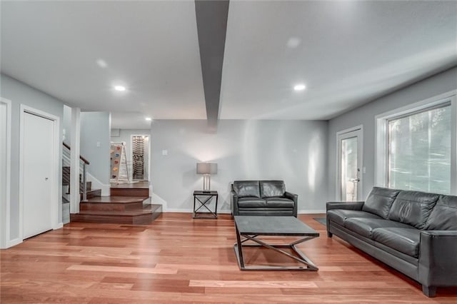 12204 Catalina St, Leawood, KS 66209 - living room with recessed lighting, light wood-style flooring, stairs, and beamed ceiling