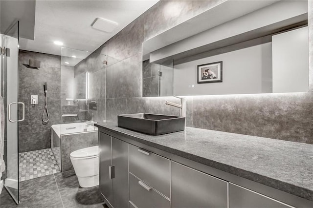 12204 Catalina St, Leawood, KS 66209 - bathroom with vanity, a shower stall, tile patterned flooring, and tile walls