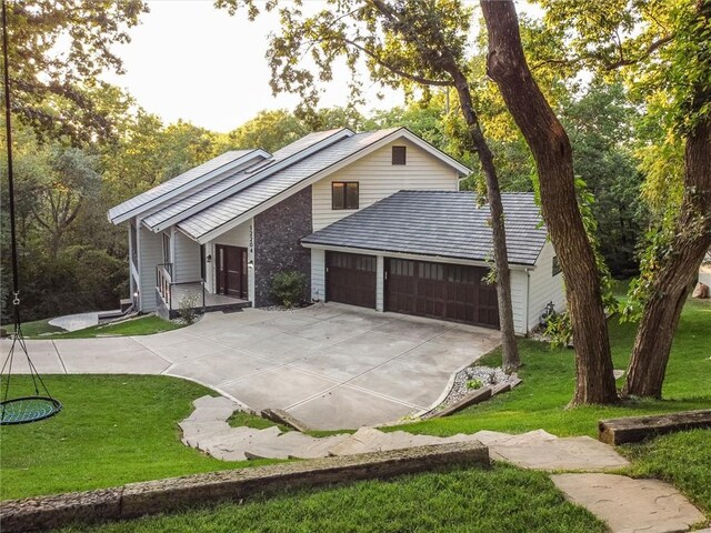 12204 Catalina St, Leawood, KS 66209 - view of front of home featuring a garage, concrete driveway, and a front yard