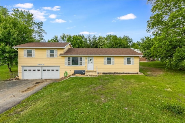 711 S Colby St, Hamilton, MO 64644 - tri-level home with asphalt driveway, a garage, and a front lawn