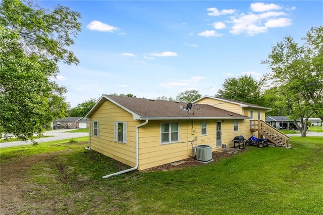 711 S Colby St, Hamilton, MO 64644 - back of house featuring a yard, cooling unit, and a shingled roof
