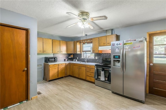 711 S Colby St, Hamilton, MO 64644 - kitchen with stainless steel appliances, ceiling fan, light wood-style flooring, under cabinet range hood, and light countertops