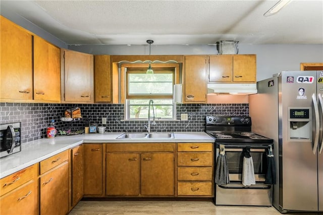 711 S Colby St, Hamilton, MO 64644 - kitchen with appliances with stainless steel finishes, a sink, under cabinet range hood, and light countertops