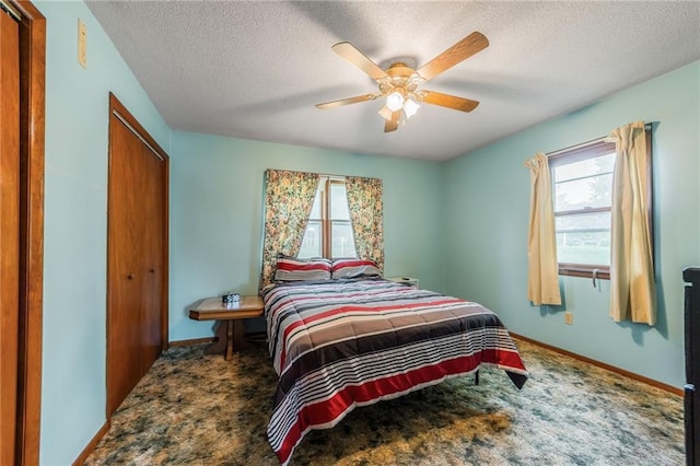711 S Colby St, Hamilton, MO 64644 - carpeted bedroom with multiple windows, a closet, a textured ceiling, and baseboards