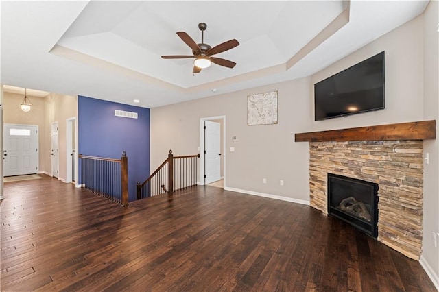 20740 W 224th St, Spring Hill, KS 66083 - unfurnished living room featuring a raised ceiling, hardwood / wood-style flooring, ceiling fan, and a fireplace