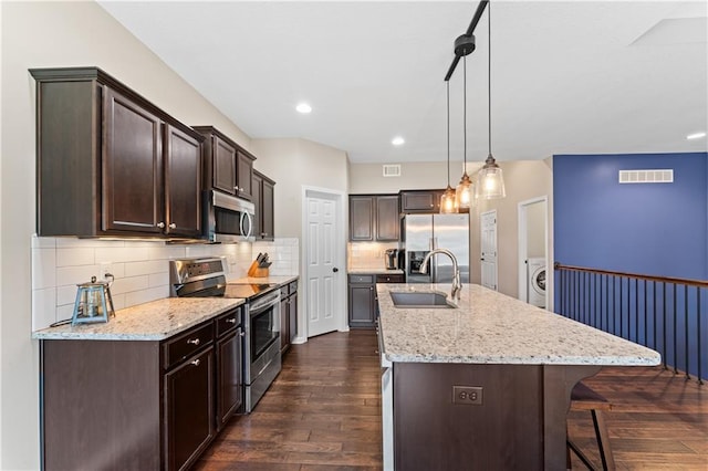 20740 W 224th St, Spring Hill, KS 66083 - kitchen featuring stainless steel appliances, washer / dryer, dark brown cabinetry, dark wood finished floors, and recessed lighting