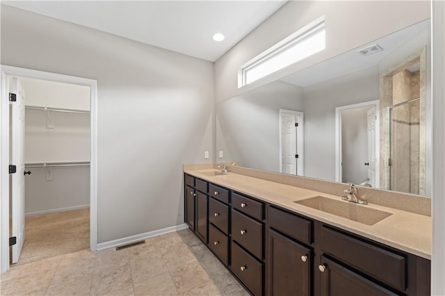 20740 W 224th St, Spring Hill, KS 66083 - bathroom with a stall shower, double vanity, and a spacious closet