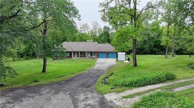 19490 Countryside Cir, Weston, MO 64098 - ranch-style home with an attached garage, asphalt driveway, and a front yard