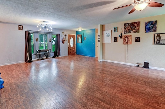 19490 Countryside Cir, Weston, MO 64098 - unfurnished living room with wood finished floors, a textured ceiling, a chandelier, baseboards, and a ceiling fan