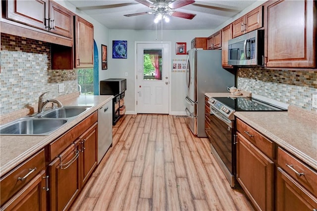 19490 Countryside Cir, Weston, MO 64098 - kitchen with stainless steel appliances, a sink, light wood-type flooring, and light countertops