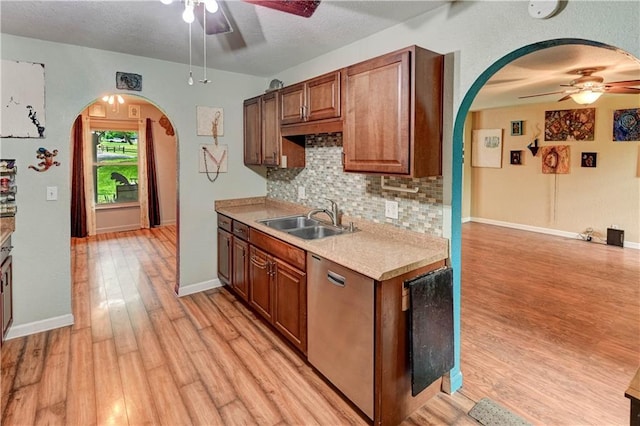 19490 Countryside Cir, Weston, MO 64098 - kitchen with ceiling fan, a sink, arched walkways, stainless steel dishwasher, and a textured ceiling
