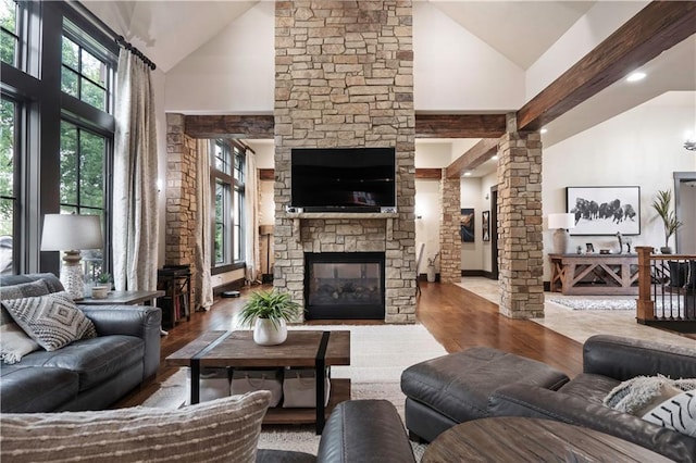 11106 W 146th Ter, Overland Park, KS 66221 - living area with high vaulted ceiling, decorative columns, a fireplace, healthy amount of natural light, and wood finished floors