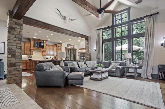 11106 W 146th Ter, Overland Park, KS 66221 - living room with high vaulted ceiling, a ceiling fan, dark wood finished floors, recessed lighting, and decorative columns