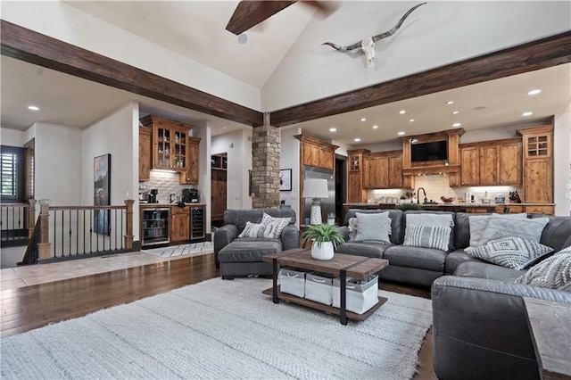 11106 W 146th Ter, Overland Park, KS 66221 - living area with wine cooler, decorative columns, dark wood-style flooring, recessed lighting, and a dry bar