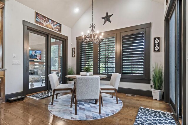 11106 W 146th Ter, Overland Park, KS 66221 - dining space with hardwood / wood-style flooring, a chandelier, high vaulted ceiling, and recessed lighting