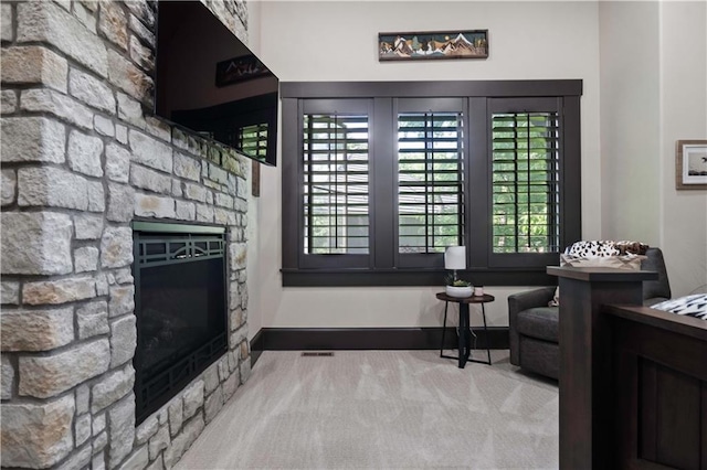 11106 W 146th Ter, Overland Park, KS 66221 - interior space with a stone fireplace, carpet flooring, and baseboards